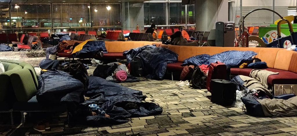 Stranded passengers sleep at Changi Airport. Photo: Deep Roy/Facebook