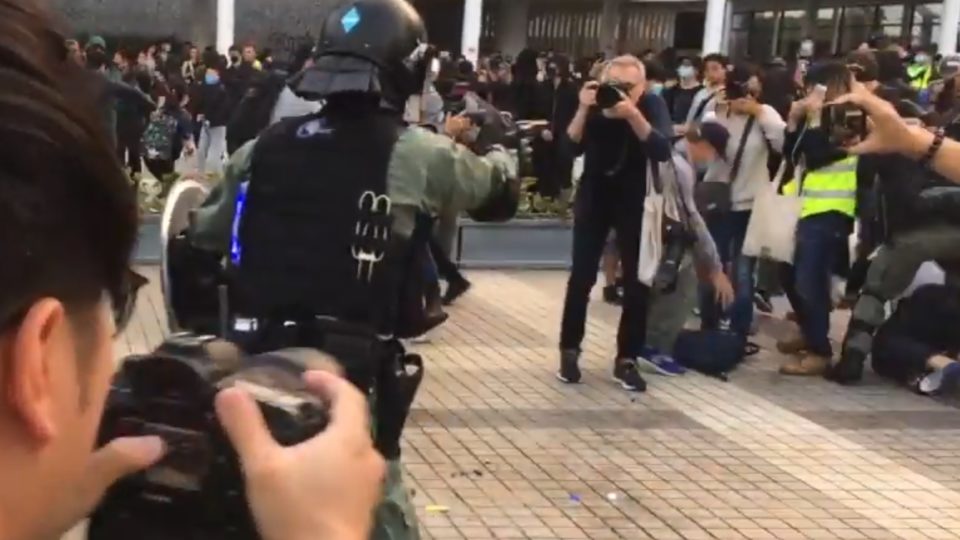 A police officer brandishing his gun at Edinburgh Place on Sunday. Screengrab via YouTube.