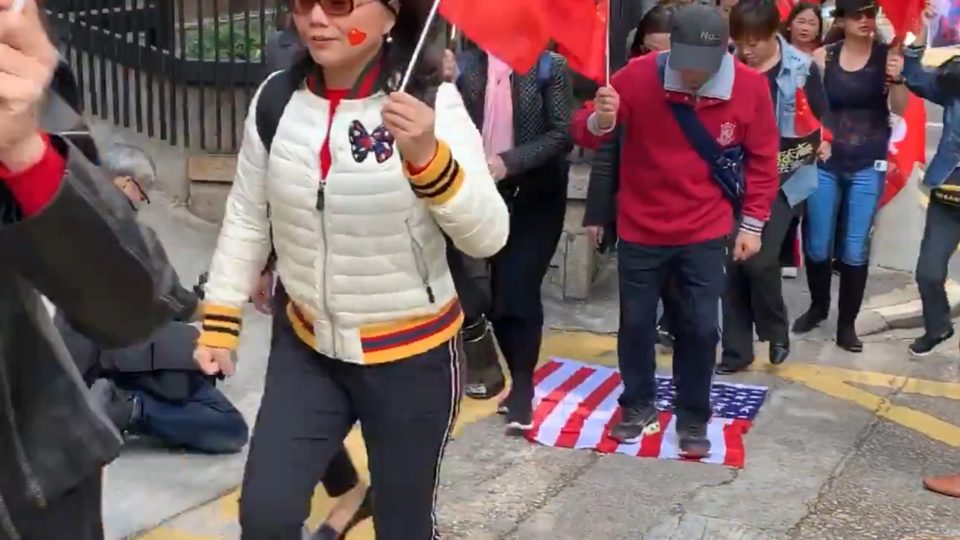 Pro-Beijing protesters angrily stomp a U.S. flag during a rally against the Hong Kong Human Rights and Democracy Act yesterday. Screengrab via Twitter/RTHK.