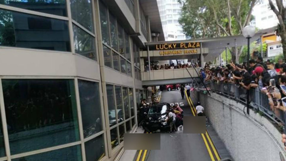 Aftermath of the crash shows a group attempting to pull out a body from underneath the car. Photo: SG Kay Poh/Facebook