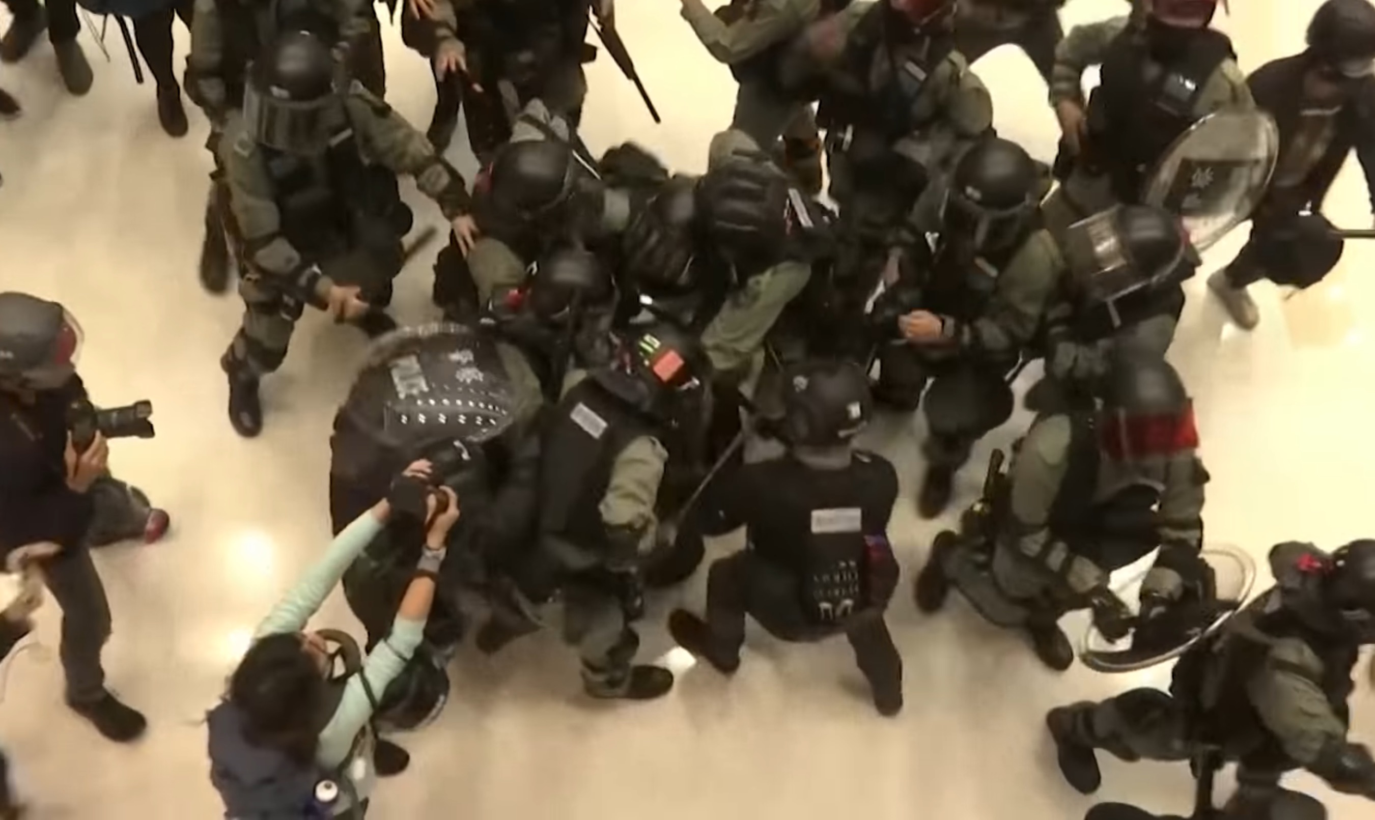 Riot police make an arrest during a scrum at the New Town Plaza shopping mall in Sha Tin on Dec. 15, 2019. Screengrab via YouTube.