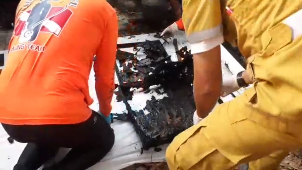 A casket on Thursday retrieved from the pond. Image: Police TV / Facebook 
