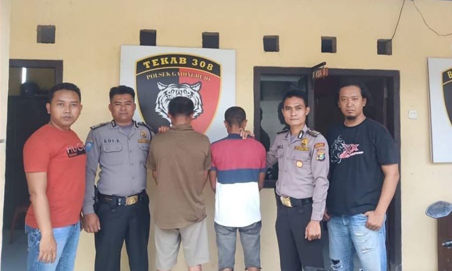 Two rape suspects facing the wall at a police station in Lampung, Indonesia. The victim is the underage stepdaughter of one of the suspects. Photo: Humas Polres Pringsewu