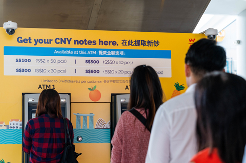 People queuing up for fresh notes at an ATM pop-up. Photo: POSB