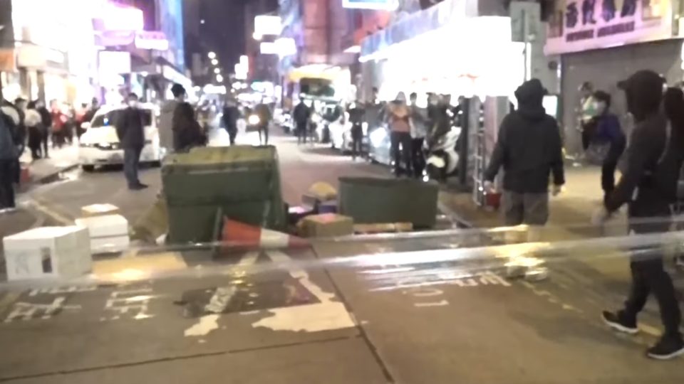 Protesters block a road in Mong Kok on Sunday as they marked the anniversary of the “Fishball Revolution.” Screengrab via YouTube.