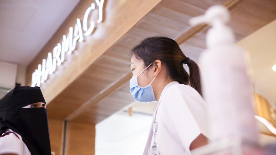 Masked healthcare worker speaking to a member of the public at Singapore’s Tan Tock Seng Hospital. Photo: Facebook