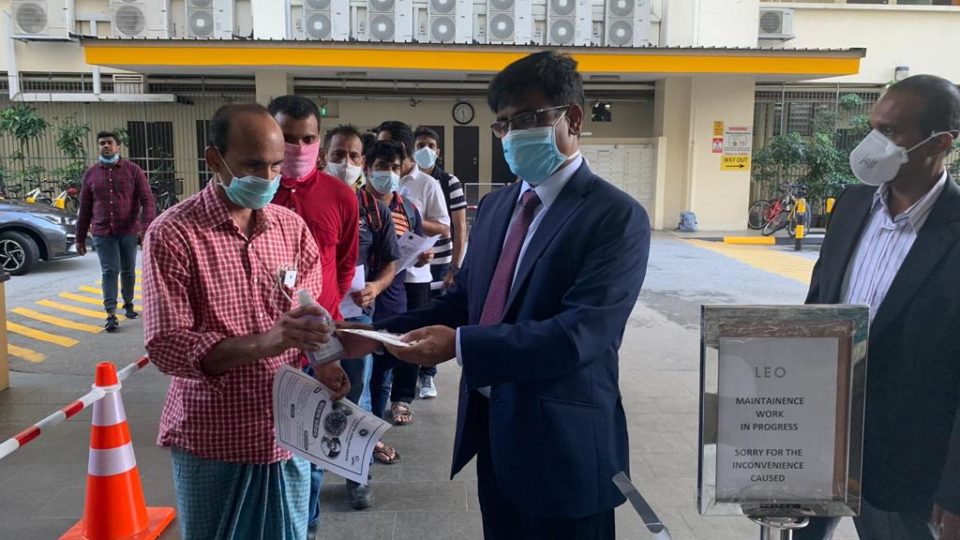 Masks and hand sanitizers being distributed at The Leo dormitory. Photo: Bangladesh High Commission, Singapore/Facebook