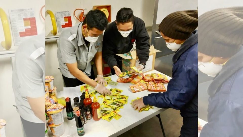 Representatives of 78 Indonesian crew members quarantined on the Diamond Princess cruise ship  anchored off the Port of Yokohama are seen sorting through the contents of the care package sent by The Indonesian Embassy in Tokyo (KBRI Tokyo). Photo: Twitter/@KBRITokyo