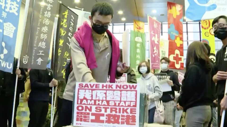 A striking healthcare worker puts a petition letter in a box, one of many to be delivered to the Hospital Authority. Screengrab via Facebook video/RTHK.