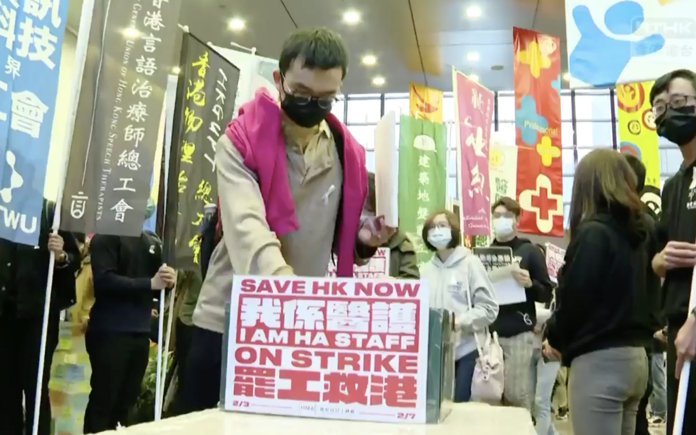 A striking healthcare worker puts a petition letter in a box, one of many to be delivered to the Hospital Authority. Screengrab via Facebook video/RTHK.
