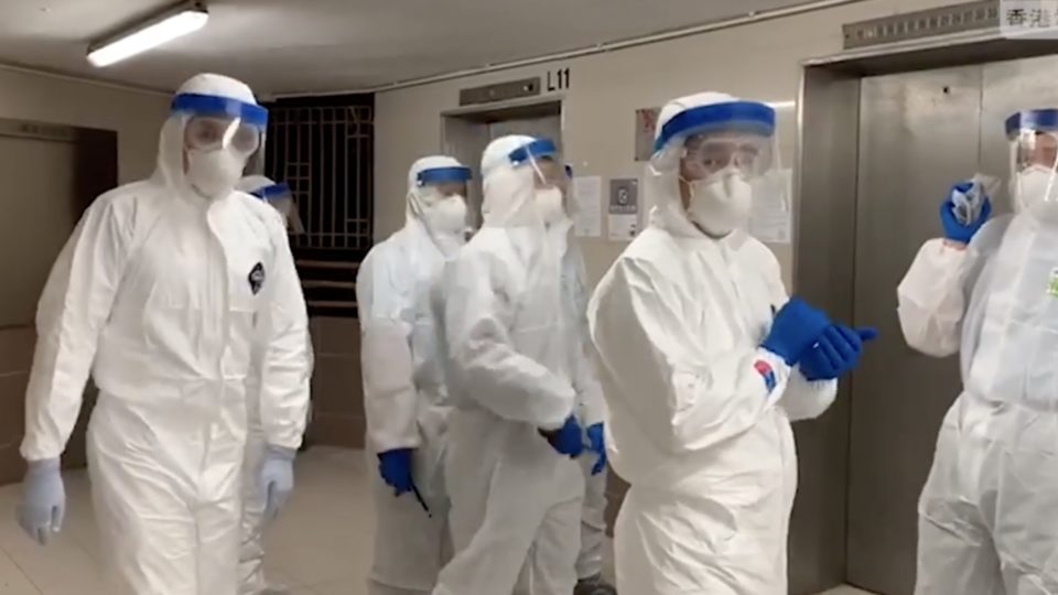 Centre for Health Protection personnel at Hong Mei House in Tsing Yi. Screengrab via Facebook/RTHK.