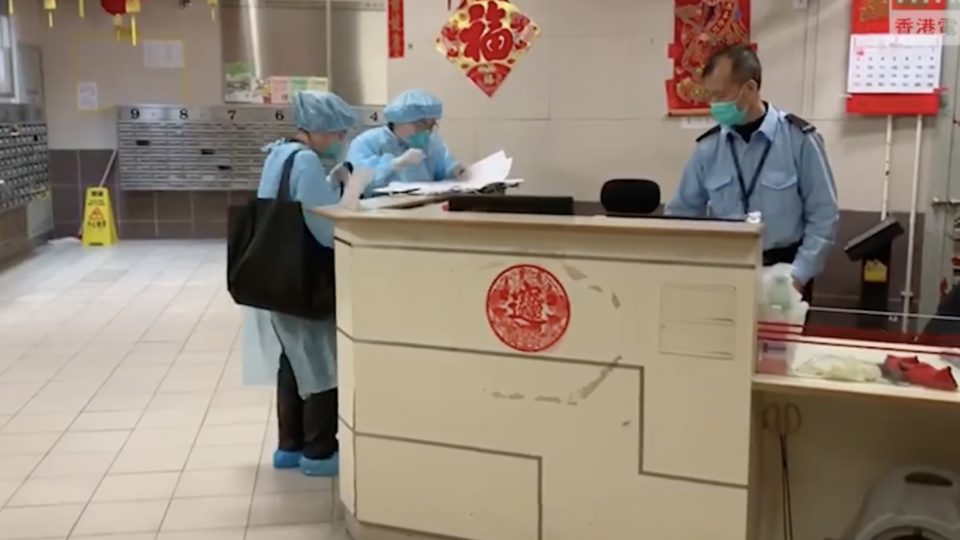 Centre for Health Protection personnel at Hong Mei House in Tsing Yi. Screengrab via Facebook/RTHK.