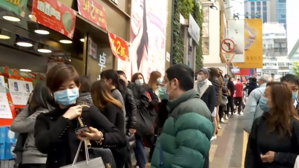 People line up outside a pharmacy in Hong Kong in February in hopes of buying face masks amid a citywide shortage. Screengrab via YouTube.