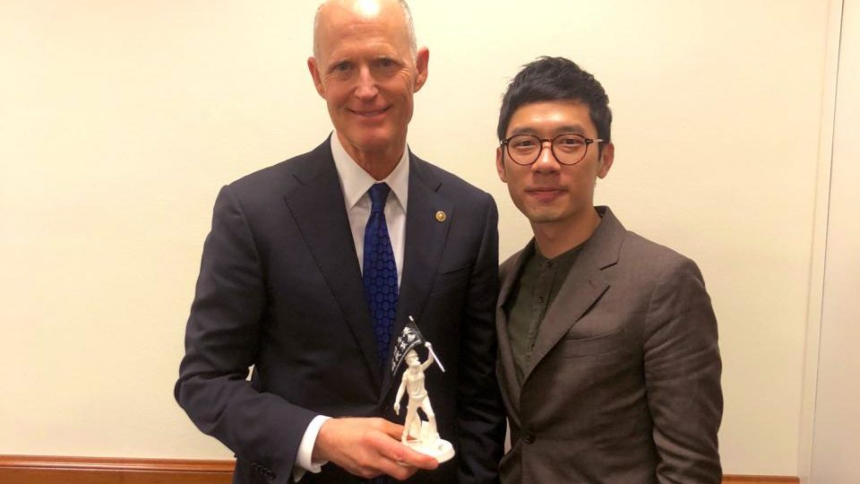 Hong Kong activist Nathan Law poses with U.S. Senator Rick Scott ahead of the annual State of the Union Address in the United States. Photo via Facebook.