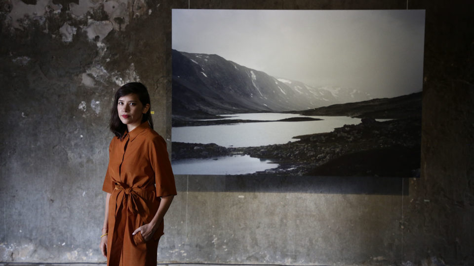 Sirikitiya Jensen poses before her photo at Bangkok Design Week’s Hundred Years Between exhibition. Photo: Bangkok Design Week / Courtesy