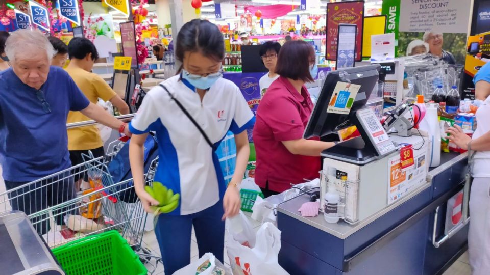 Shoppers paying for their groceries at an NTUC Fairprice supermarket outlet in a photo dated Feb. 10. Photo: NTUC Fairprice/Facebook