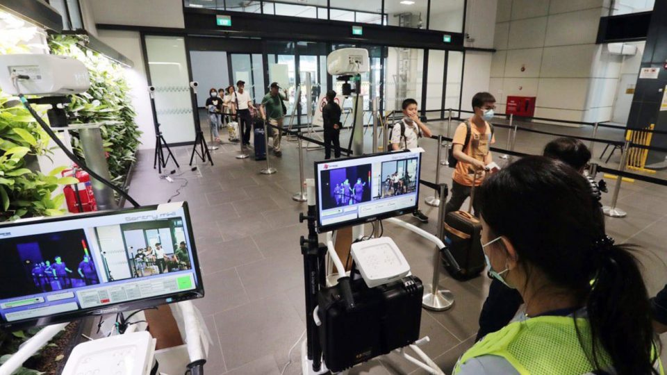 Staff monitor commuters’ body temperatures in Singapore. Photo: Lawrence Wong/Facebook