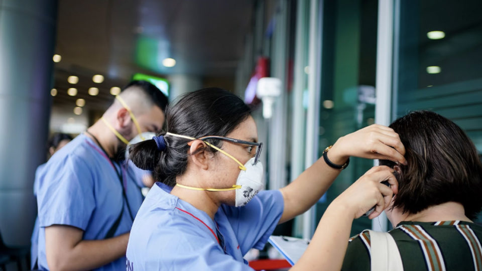 Temperature checks conducted at a hospital in Singapore in a file photo. Photo: Jurong Health Campus/Facebook