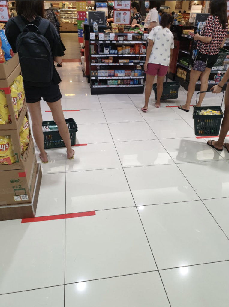 Staggered queues are marked by tape at a Singapore supermarket. Photo: Branson Lee/Twitter