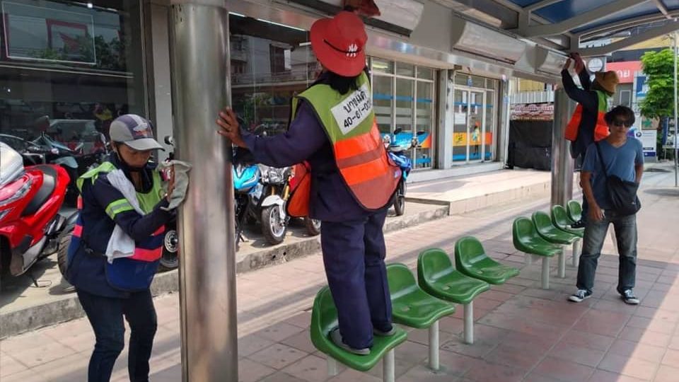 City workers clean a bus Bangkok bus stop. Photo: BMA