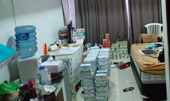Boxes of face masks stockpiled for resale at the suspect’s apartment in Central Jakarta. Photo: Instagram/@polsek_menteng