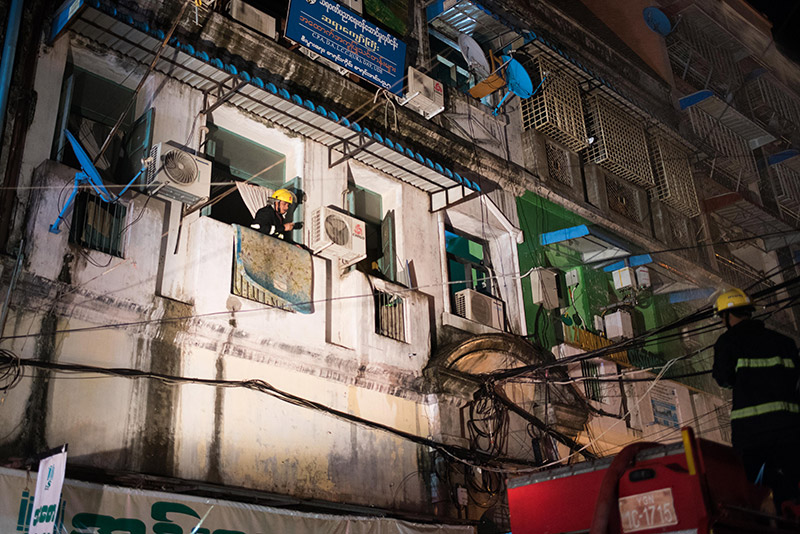 Yangon firefighters at the scene of Thursday night's blaze on 37th Street in Kyauktada Township. Photo: Ludivine Paques 