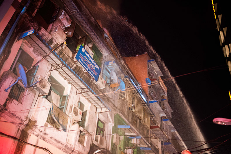 Yangon firefighters at the scene of Thursday night's blaze on 37th Street in Kyauktada Township. Photo: Ludivine Paques 