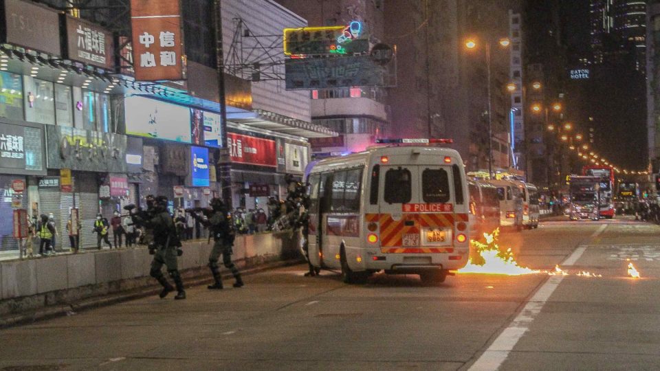 A fire burns near a police van during protests in Mong Kok on Feb. 29, 2020. Photo: Tommy Walker