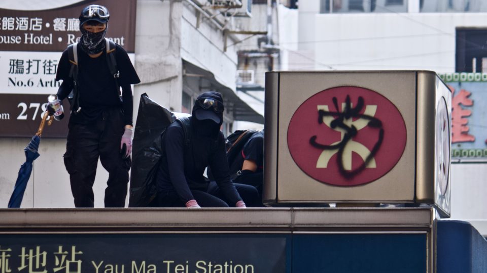 Protesters at a rally in October 2020 graffiti the MTR logo on top of an entrance at Yau Ma Tei station. Photo by Vicky Wong.