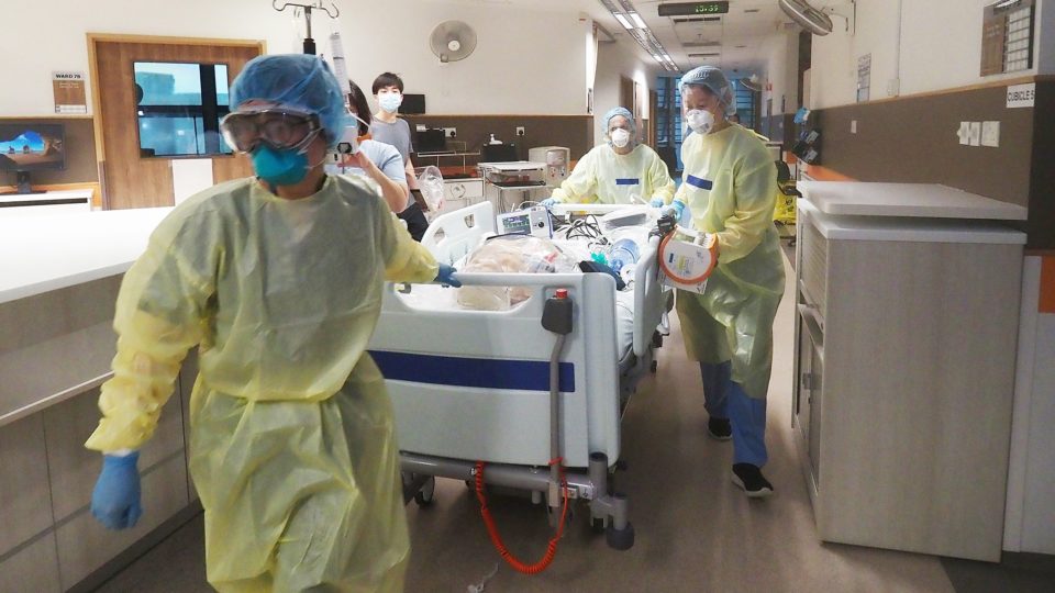 Medical workers wheel a patient at a Singapore hospital in a photo dated April 14, 2020. Photo: Tan Tock Seng Hospital/Facebook