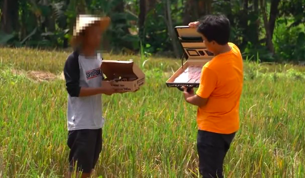 Indonesian Youtuber hasanjr11 (Right) offering a farmer IDR10 million to break his fast. Photo: Video screengrab.