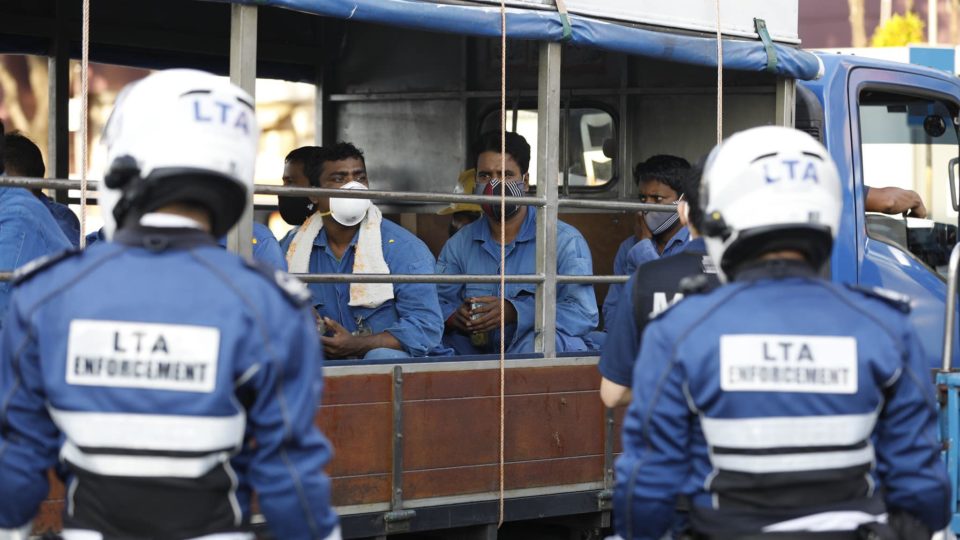 Enforcement officers in Singapore conduct safe-distancing checks on migrant workers in a photo dated April 17, 2020. Photo: Ministry of Manpower/Facebook