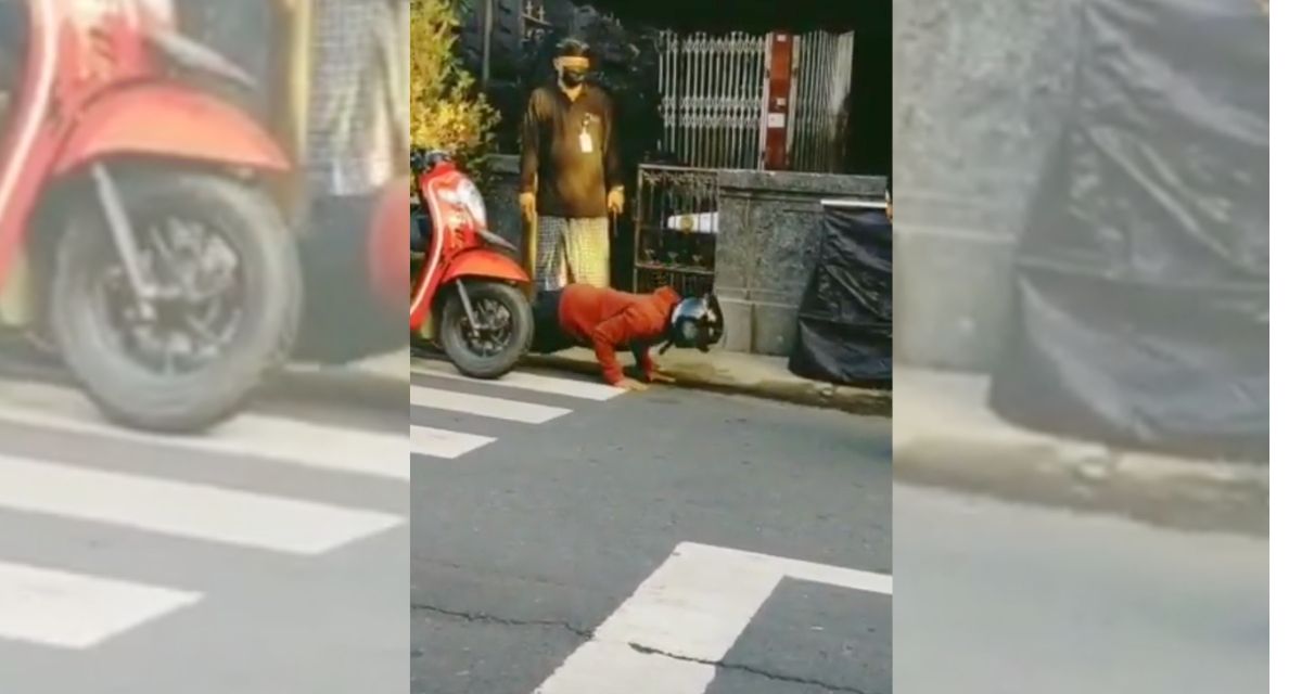 A screengrab from a video showing a motorbike driver without a mask having to endure several push-ups. Screengrab: Instagram