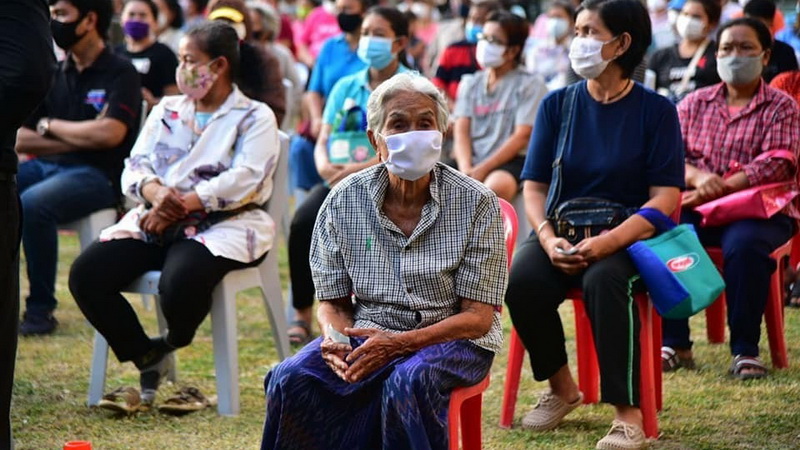 Bangkok residents wait to receive food donations Wednesday at City Hall.
