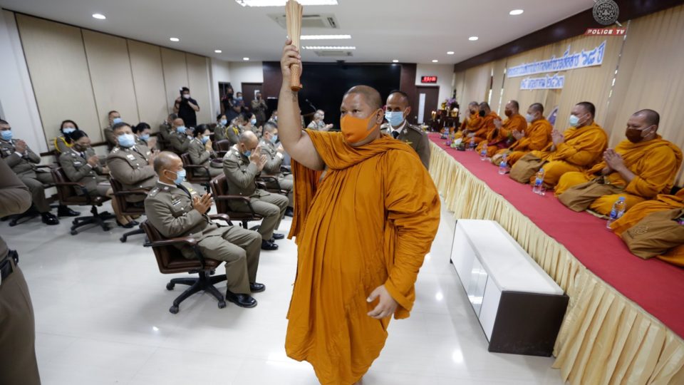 Buddhist monks sprinkle holy water at a police station. Photo: Police TV / Facebook
