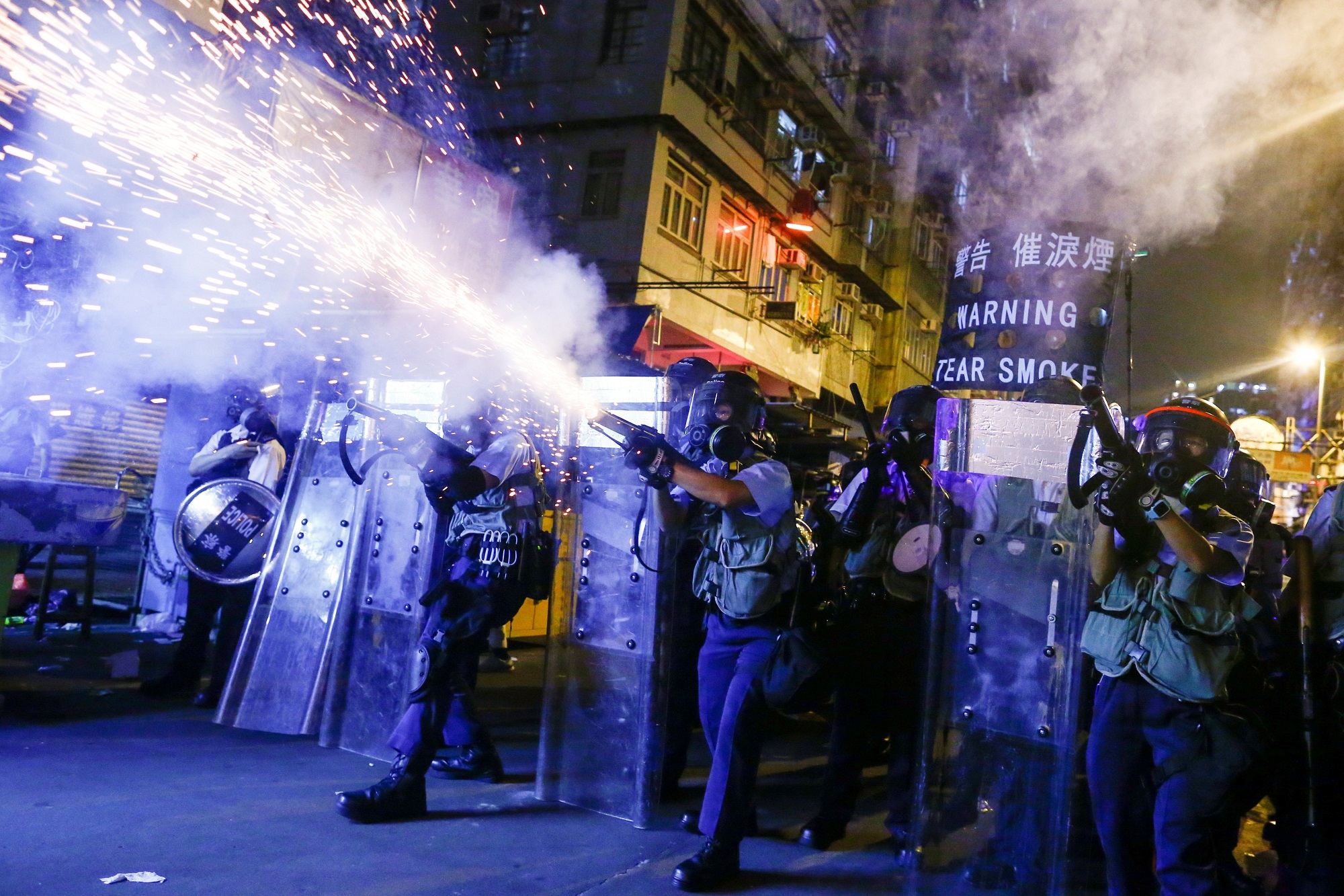 Police fire tear gas at protesters during clashes in the Sham Shui Po neighborhood of Hong Kong in mid-August. Photo: Thomas Peter/Reuters