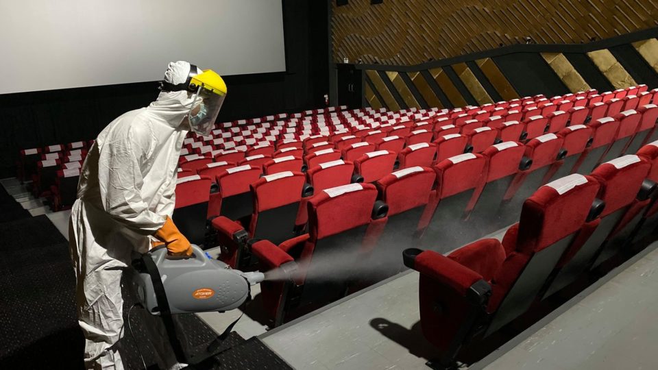 A health worker sprays disinfectant inside a cinema of MVP chain.