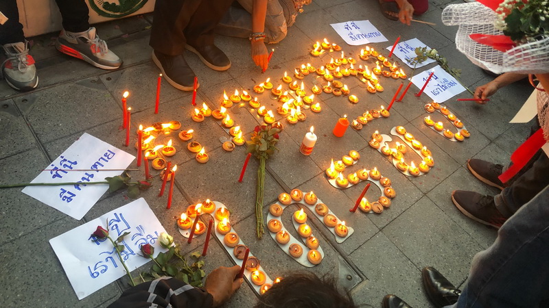 “The truth, who opened fire?” reads an arrangement of candles lit by the Redshirt activists Tuesday evening at Ratchaprasong intersection on the 10th anniversary of an army crackdown on mass demonstrations that left dozens dead, including six shot to death at a nearby temple.