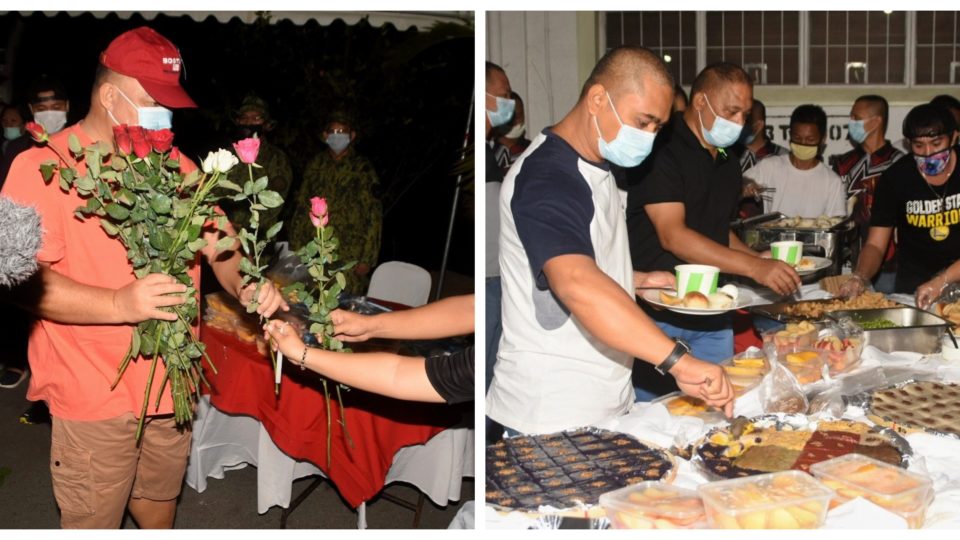 High-ranking Metro Manila cop Debold Sinas accepts roses from staff during birthday event while his men eat from buffet spread. Photo: NCRPO/FB 