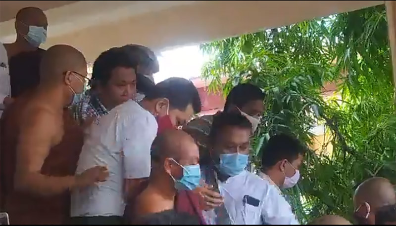 A man accused of insulting Buddhism for criticizing and mocking monks is led Tuesday from the Koenawin Monastery in Meiktila. Still image from video.