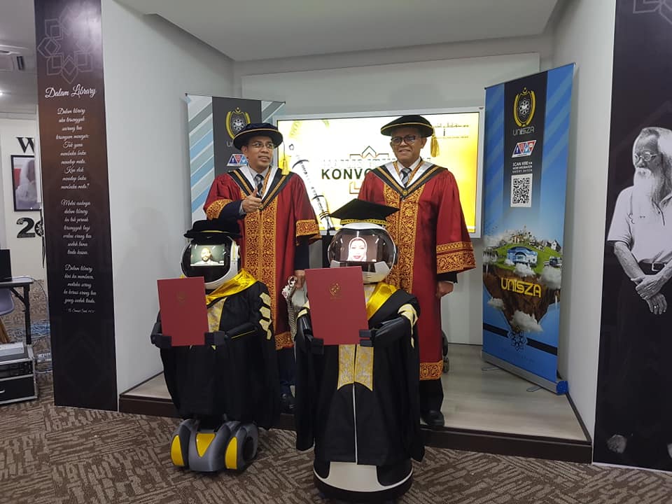 The simulation robots strike a pose they receive their scrolls. Photo: Universiti Sultan Zainal Abidin / Facebook