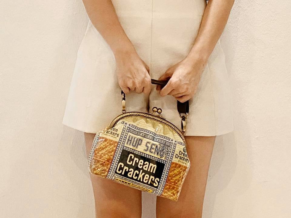 Woman holding a clasp handbag made with Hup Seng Cream Crackers’ packaging. Photo: Wan’s Handmade /Facebook