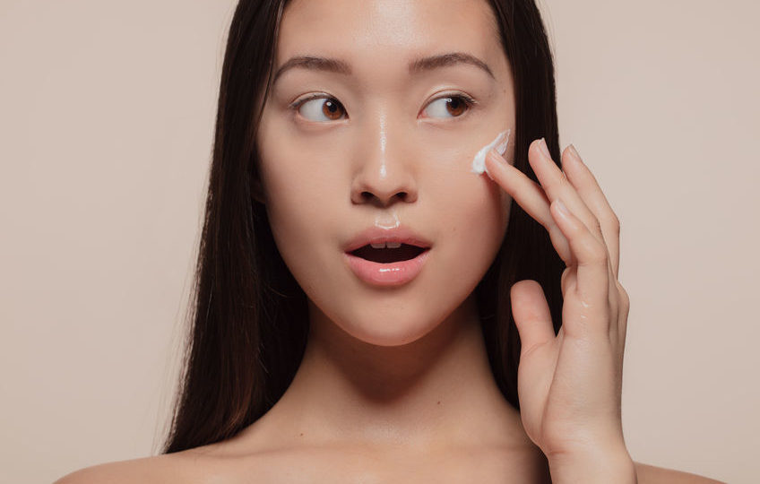 Woman applying cream to her face. Photo: ammentorp