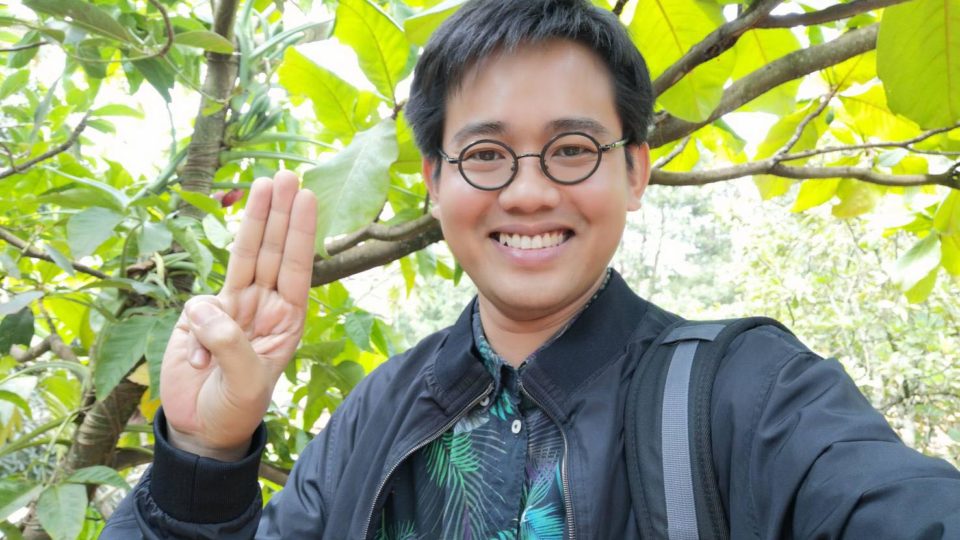 A file photo of Wanchalerm Satsaksit raising three fingers as a symbol against dictatorship. 
