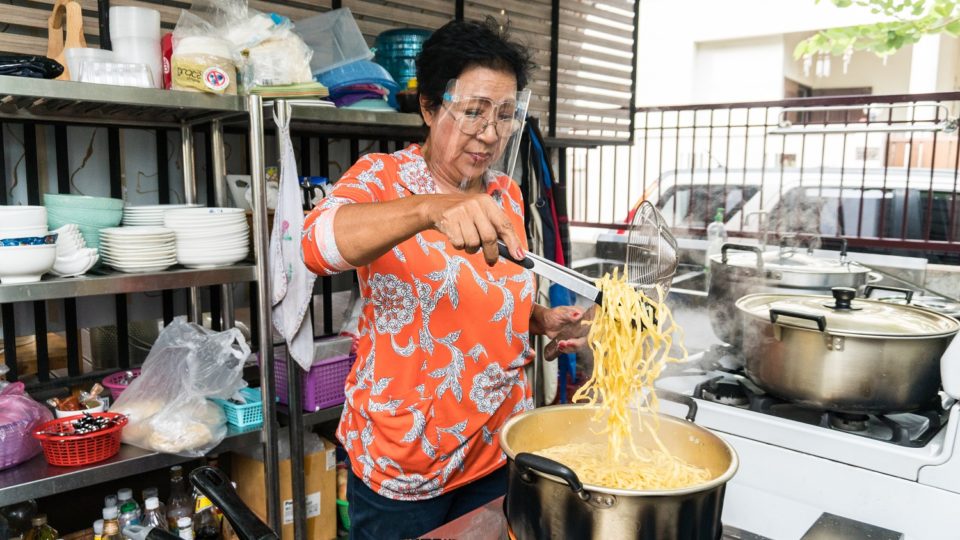 Siripha ‘Lek’ Chariton blanches egg noodles for her khao soi. Photo: Coconuts
