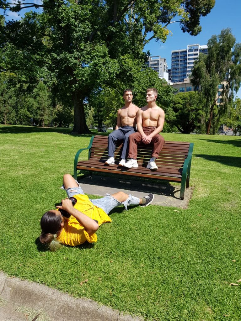 Daniel Adams lying on the ground to photograph his subjects. Photo: Daniel Adams