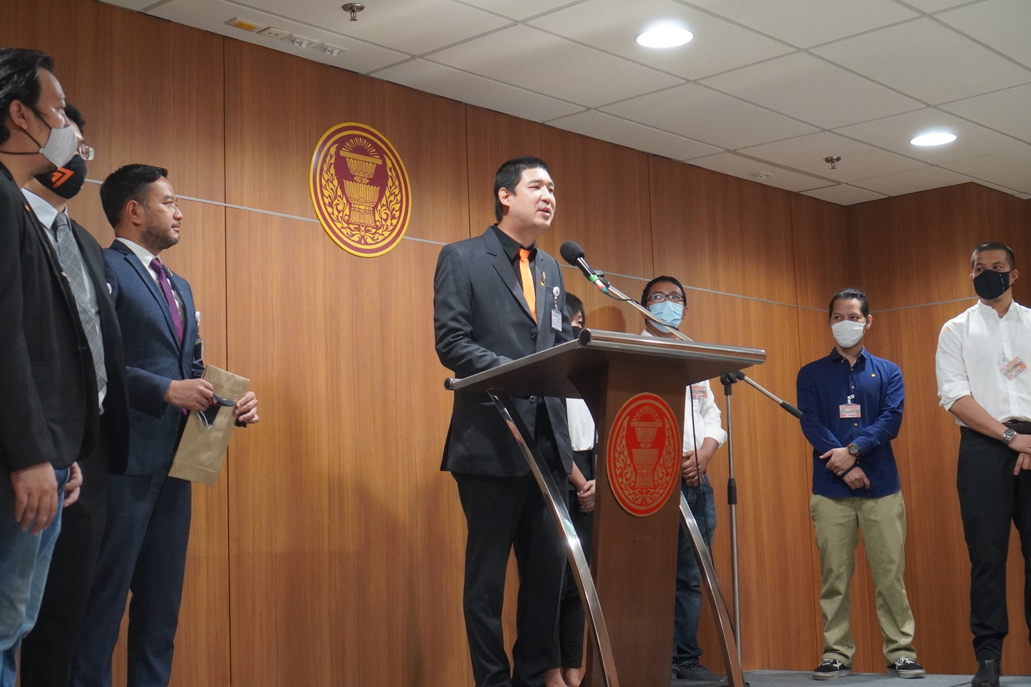 Taopiphop Limjittrakorn, “beer activist” and MP of Move Forward Party, talks at a podium on Thursday asking authorities to revoke the Section 32.
