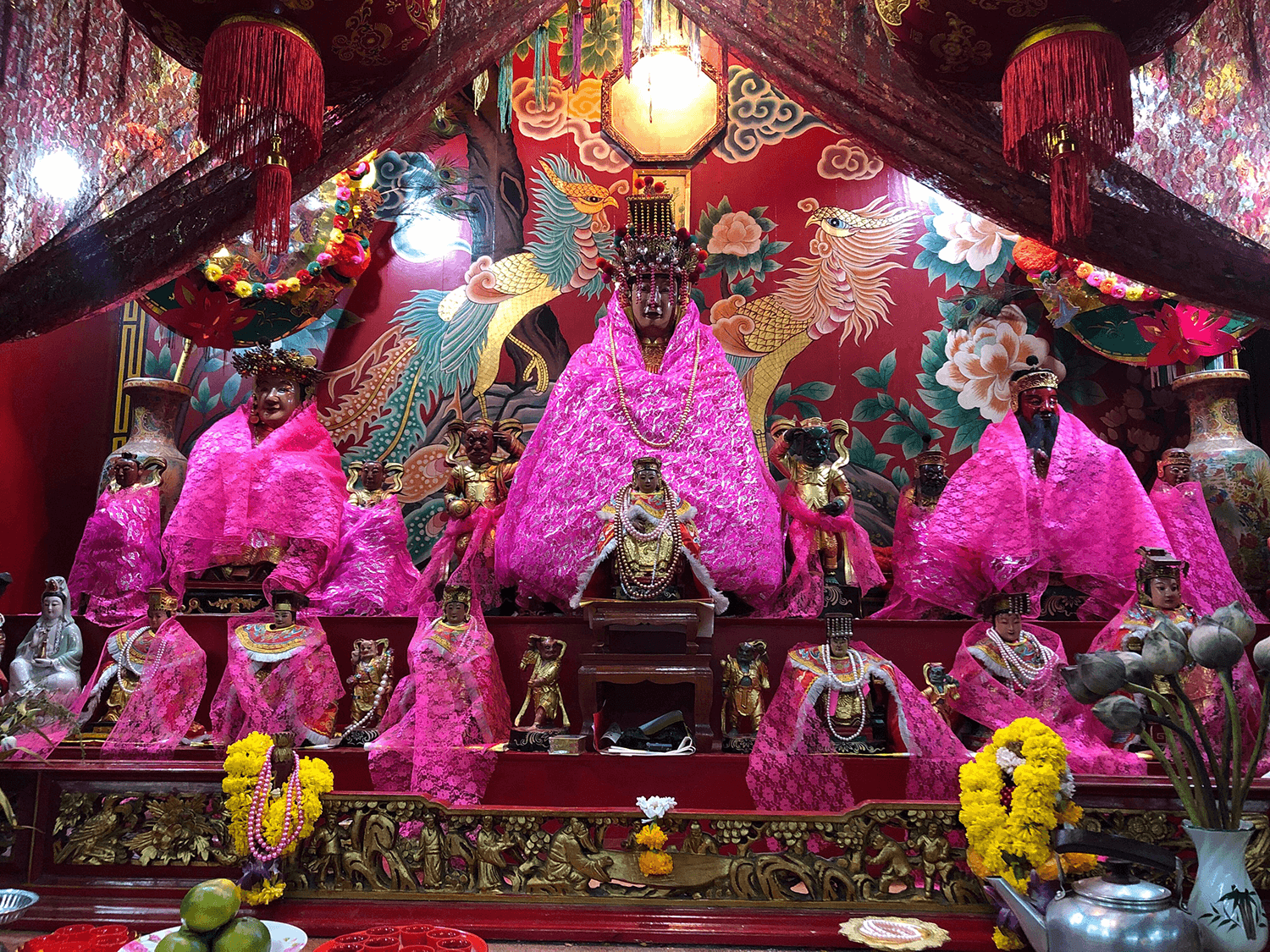 Wooden statue of the Tubtim goddess is surrounded by other Chinese gods and goddesses. Photo: Coconuts