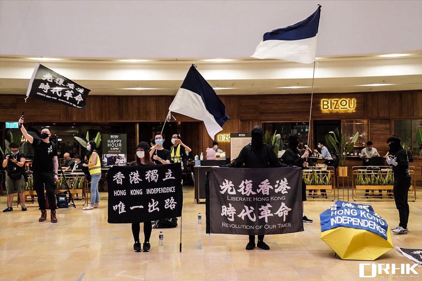 Hong Kong protesters wave flags at Pacific Place mall in Admiralty on June 15, 2020. Photo via Stromile Li for Daily Record/Facebook