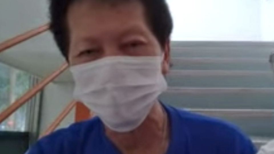 Lee Teng Kan, 67, chats with Coconuts Singapore via a video call from a stairwell in one of the Woodlands buildings he cleans.